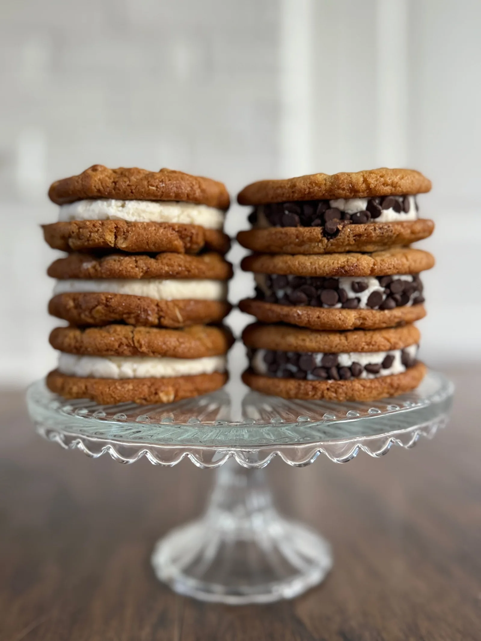 Sandwich cookies stacked on a glass stand