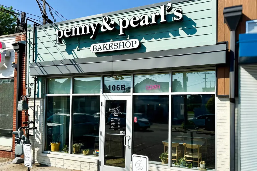 The mint Penny & Pearl’s storefront, with its white sign and 106B above the door